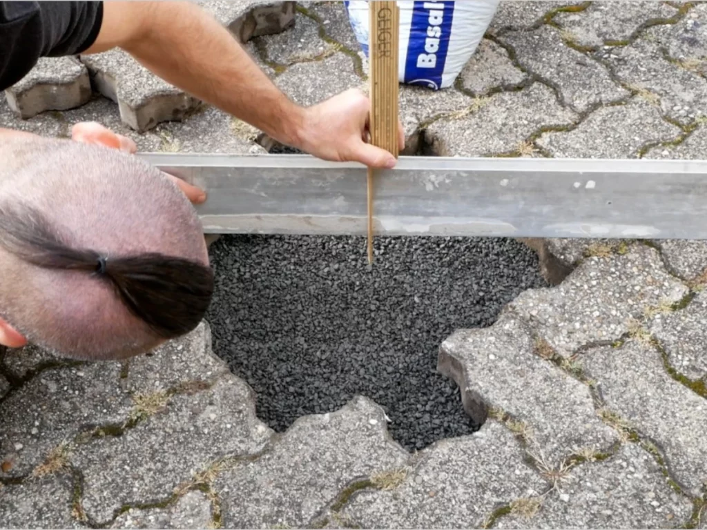 Pflastersplitt unter Pflastersteine auffüllen