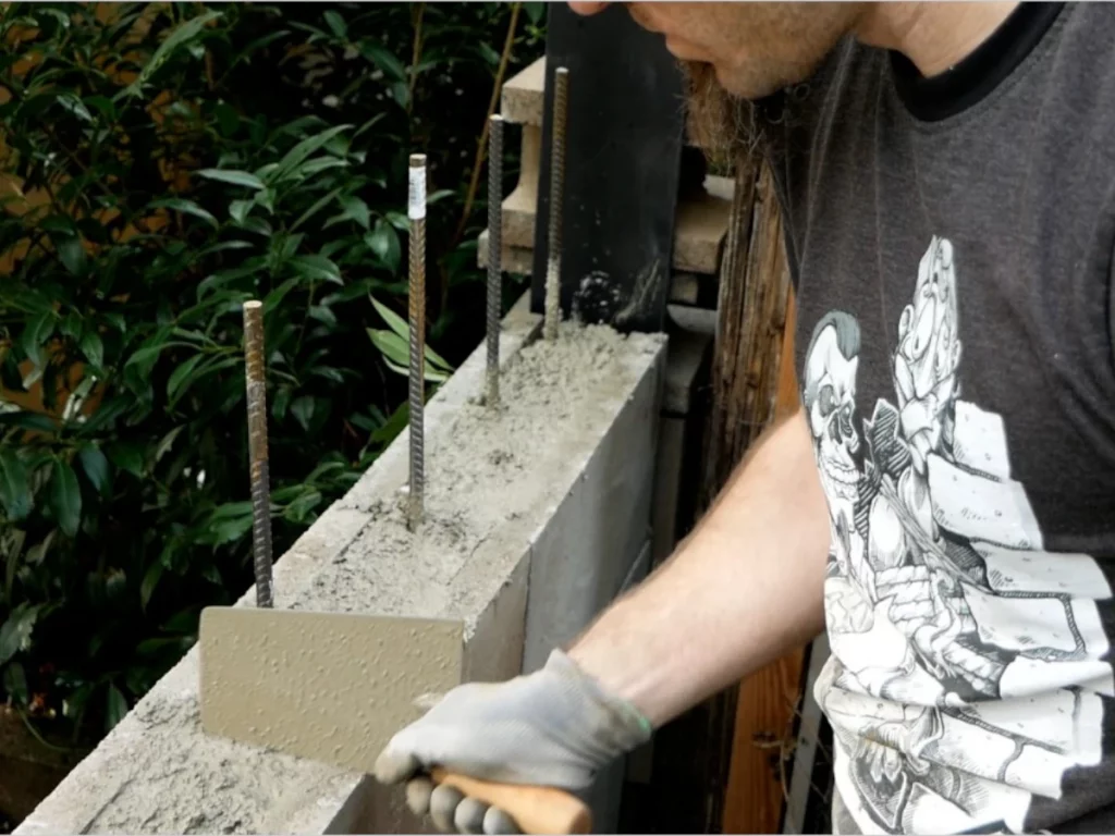 Auffüllen von Hohlkammersteinen mit Beton für stärkeren Halt und bessere Isolation